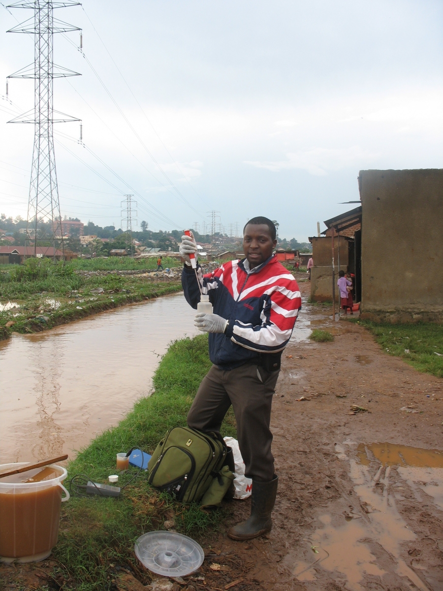 PhD student Philip Nyenje at work: measuring the discharge in Nsooba drain with the salt dilution method